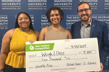 Gazzinelli Lab members hold giant check awarded them in the new venture competition.